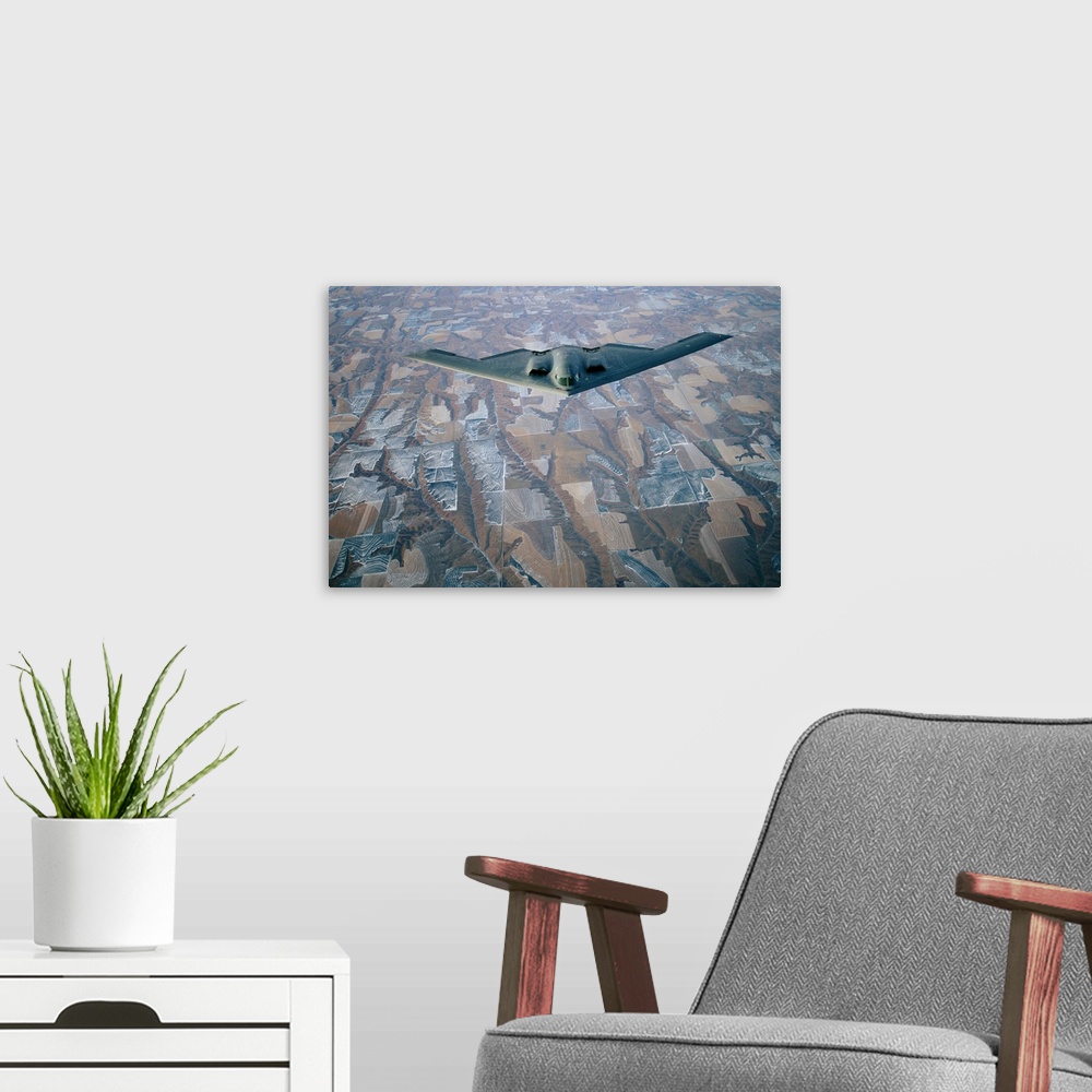 A modern room featuring A B-2 Stealth bomber over the patterned terrain of southwestern Nebraska.