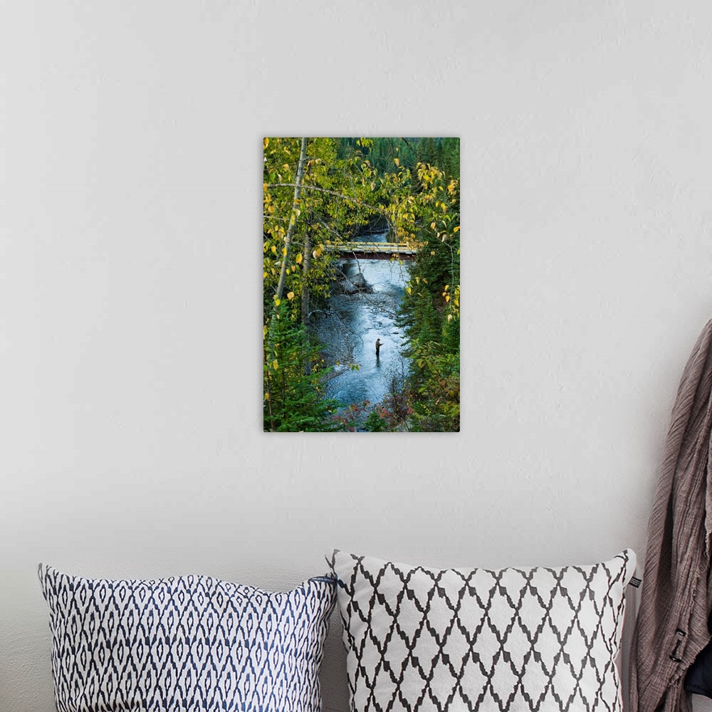 A bohemian room featuring A fisherman in Bighorn Creek, part of the Kootenay River system.