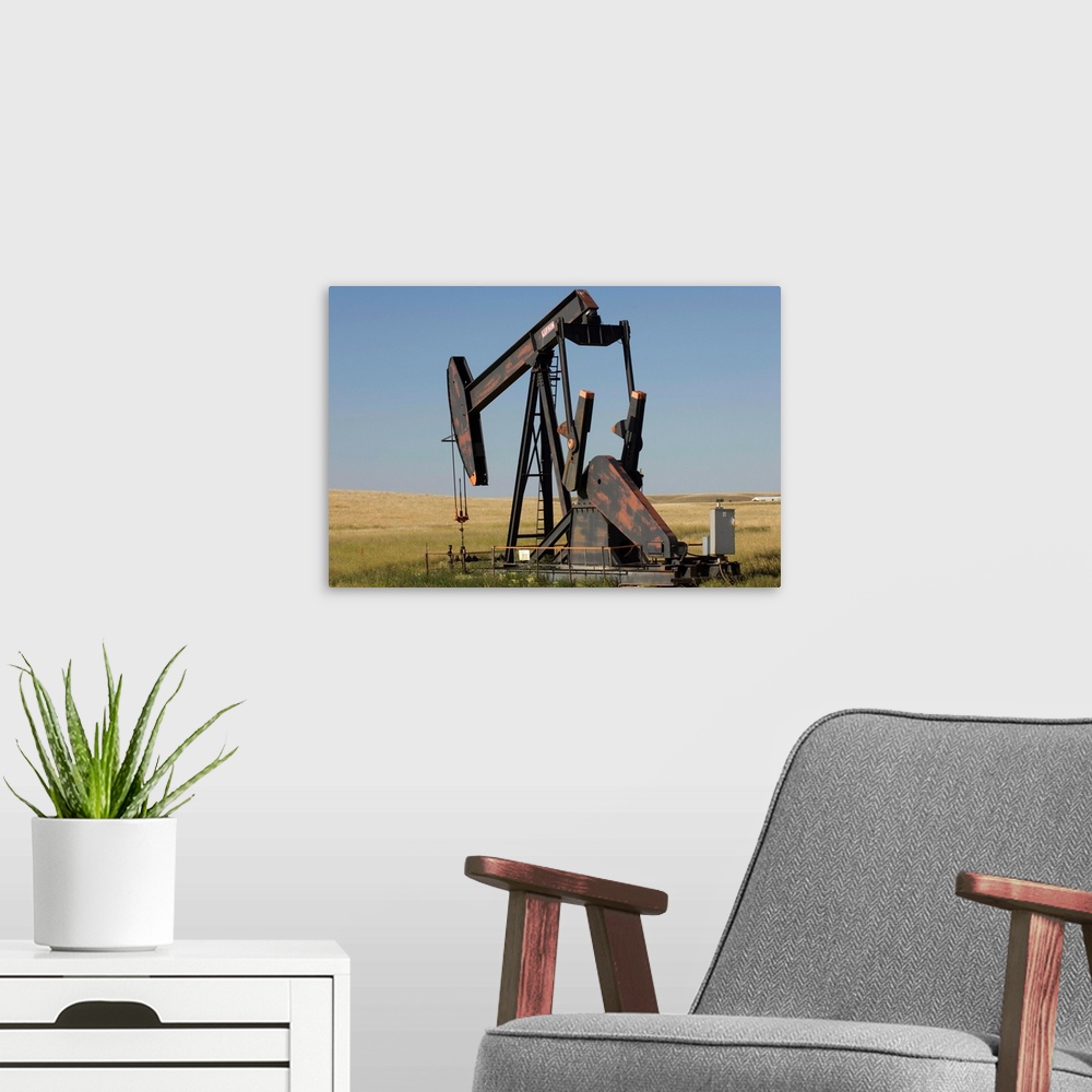 A modern room featuring An oil rig pumps oil from the Montana ground.