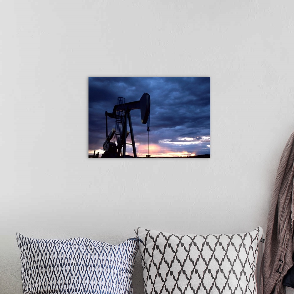 A bohemian room featuring An oil rig silhouetted at sunset.