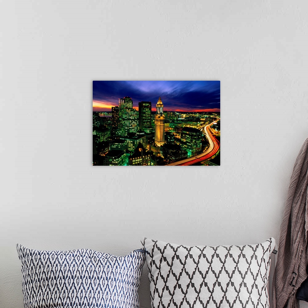 A bohemian room featuring Time lapsed evening photograph of the Custom House Tower and the highway that passes in front of it.