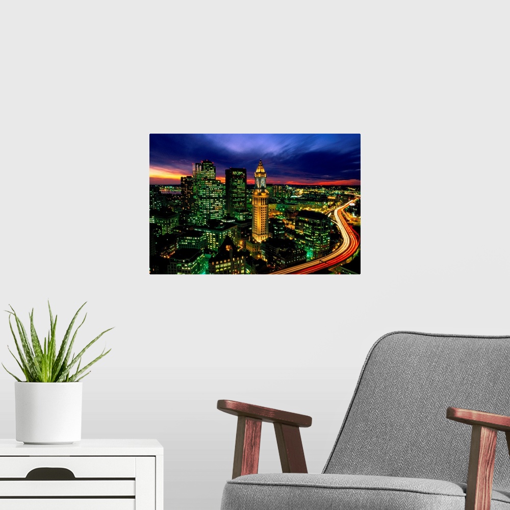 A modern room featuring Time lapsed evening photograph of the Custom House Tower and the highway that passes in front of it.