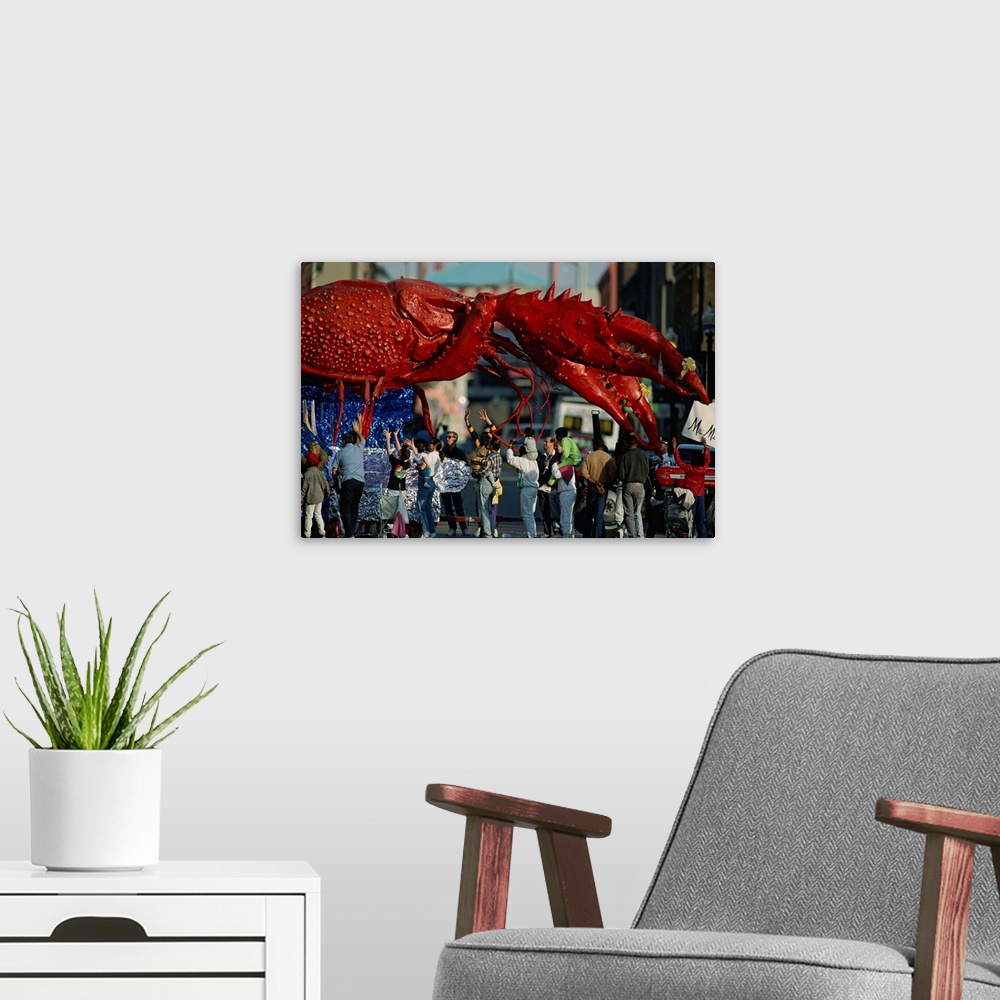 A modern room featuring Louisianans revel beneath a giant crayfish Mardi Gras float.