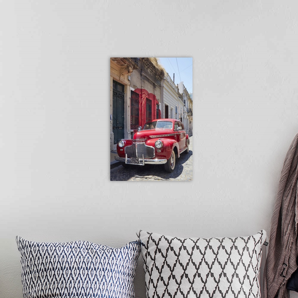 A bohemian room featuring A vintage Chevrolet Master Deluxe car in front of a colonial house in San Telmo, Buenos Aires, Ar...