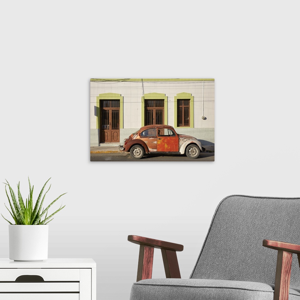 A modern room featuring A vintage Volkswagen Beetle in front of a house in Merida, Yucatan, Mexico.