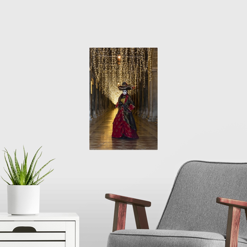 A modern room featuring A woman in costume poses in St. Mark's square during the Venice Carnival, Venice, Veneto, Italy