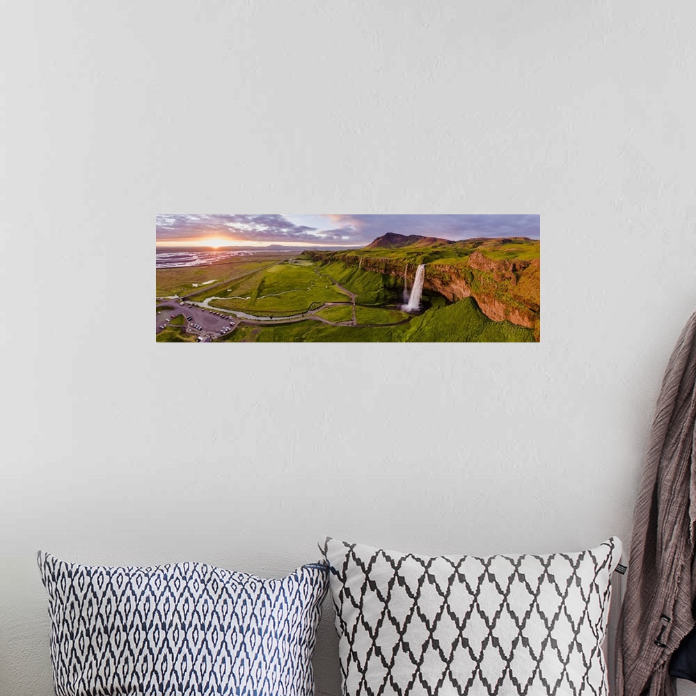 A bohemian room featuring Aerial drone view of Seljalandsfoss waterfall at sunset, Iceland