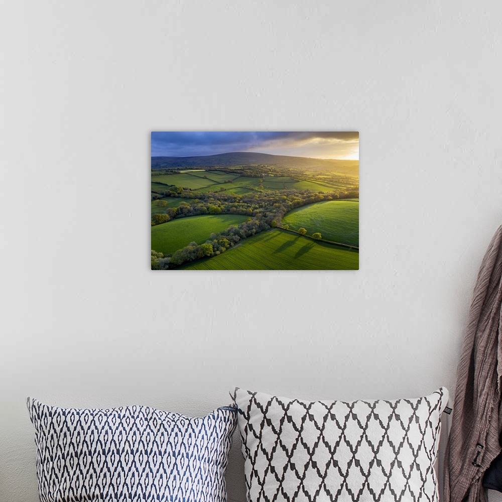 A bohemian room featuring Aerial photo of rolling countryside in evening light, Livaton, Devon, England. Spring (April) 2019.