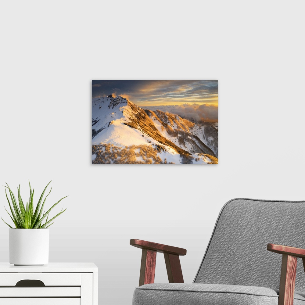 A modern room featuring aerial sunset in winter time taken by drone of Gendarme Mountain, Tuscan-Emilian Apennine Nationa...