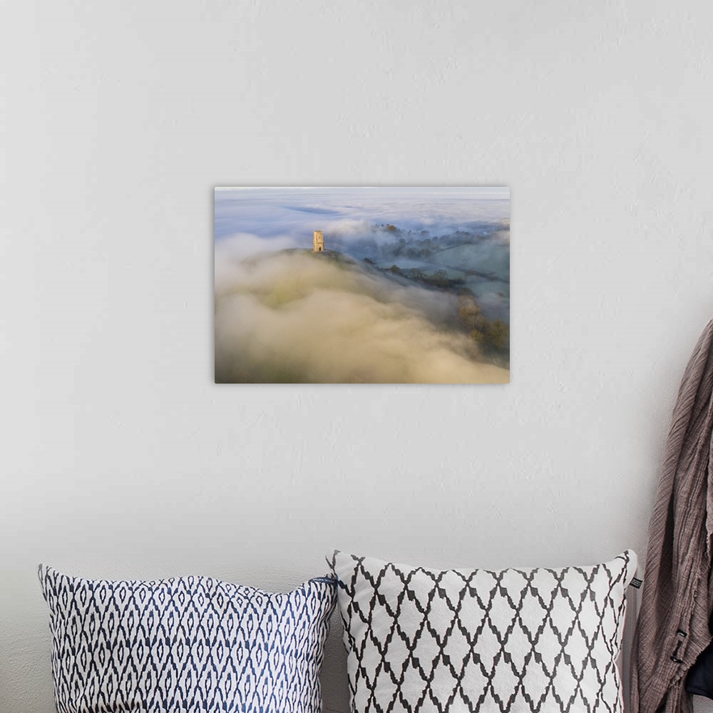 A bohemian room featuring Aerial view of Glastonbury Tor surrounded by morning mist, Glastonbury, Somerset, England