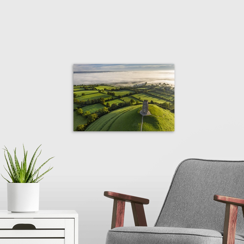 A modern room featuring Aerial view of St. Michael's Tower on Glastonbury Tor on a misty autumn morning, Somerset, Englan...
