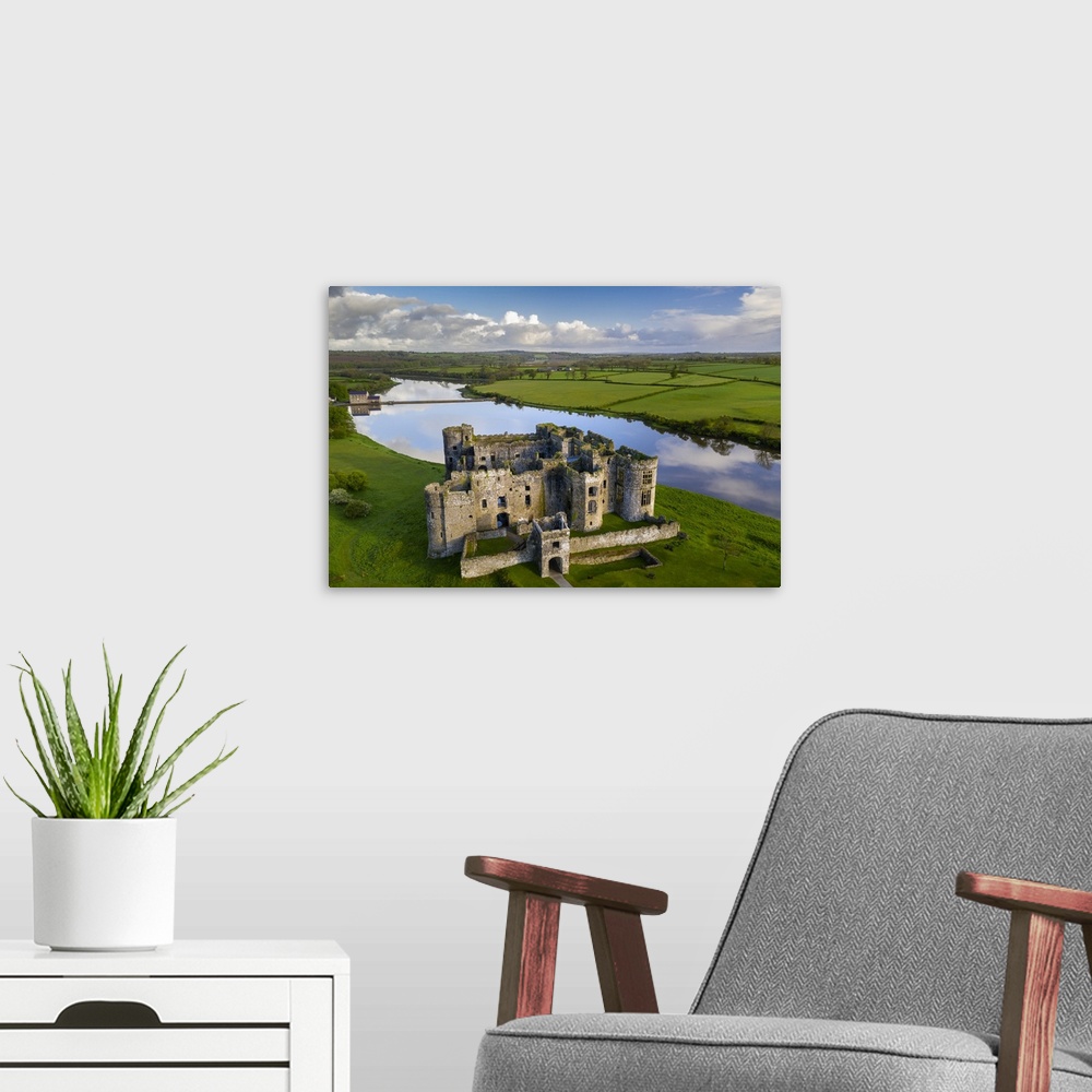 A modern room featuring Aerial vista of Carew Castle in Pembrokeshire Coast National Park, Wales, UK. Spring (May) 2021.