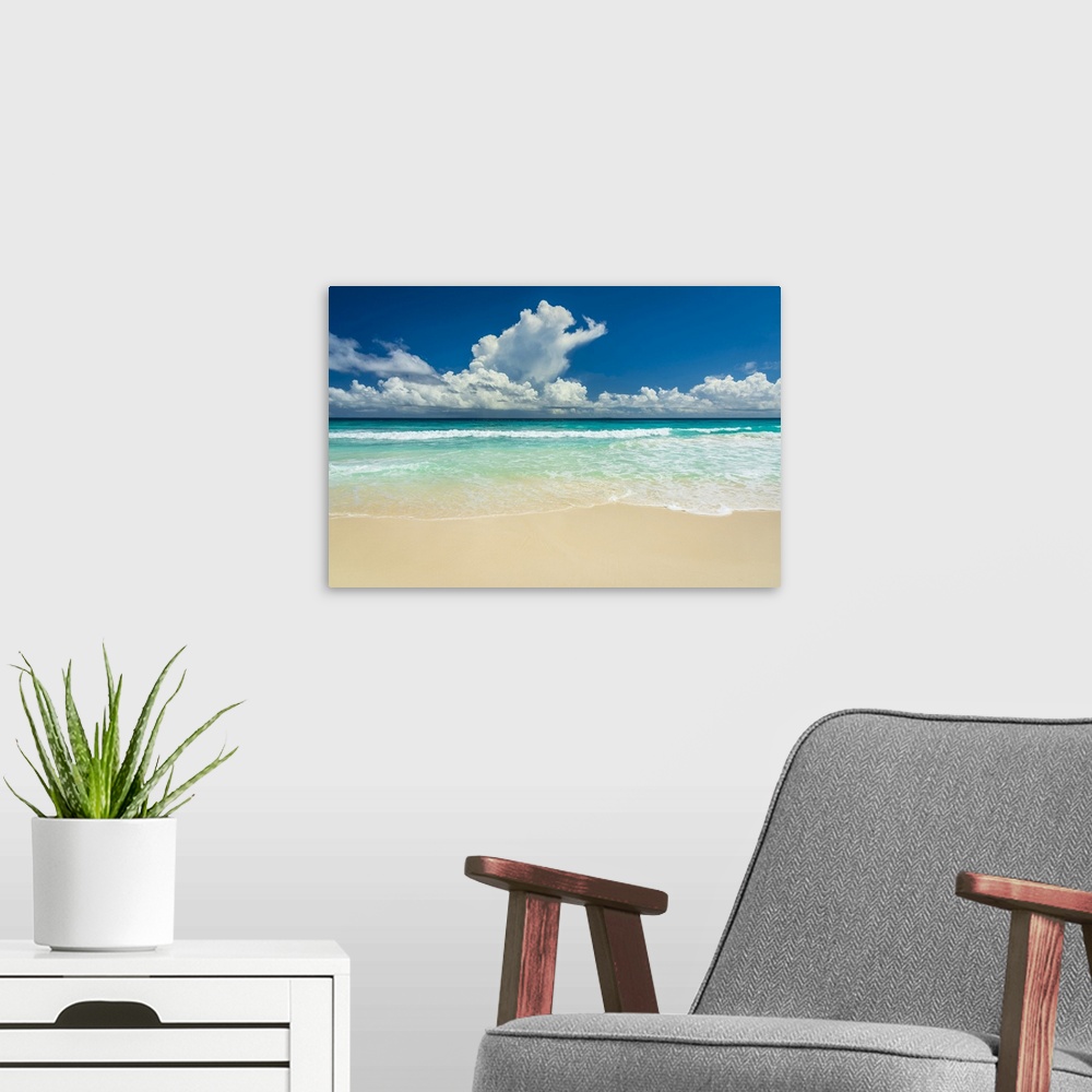 A modern room featuring Africa, Seychelles, La Digue. Beach, sand, waves, clouds at Grand Anse.