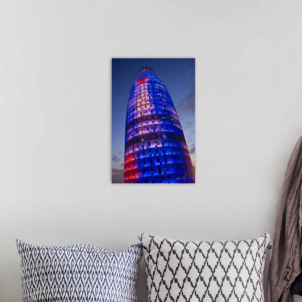 A bohemian room featuring Agbar Tower, 142m skyscraper by architect Jean Nouve, Glorias Square, Barcelona, Spain.