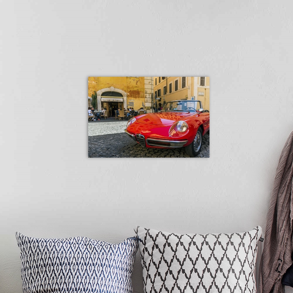 A bohemian room featuring Alfa Romeo Duetto spider parked in a cobblestone street of Rome, Lazio, Italy.