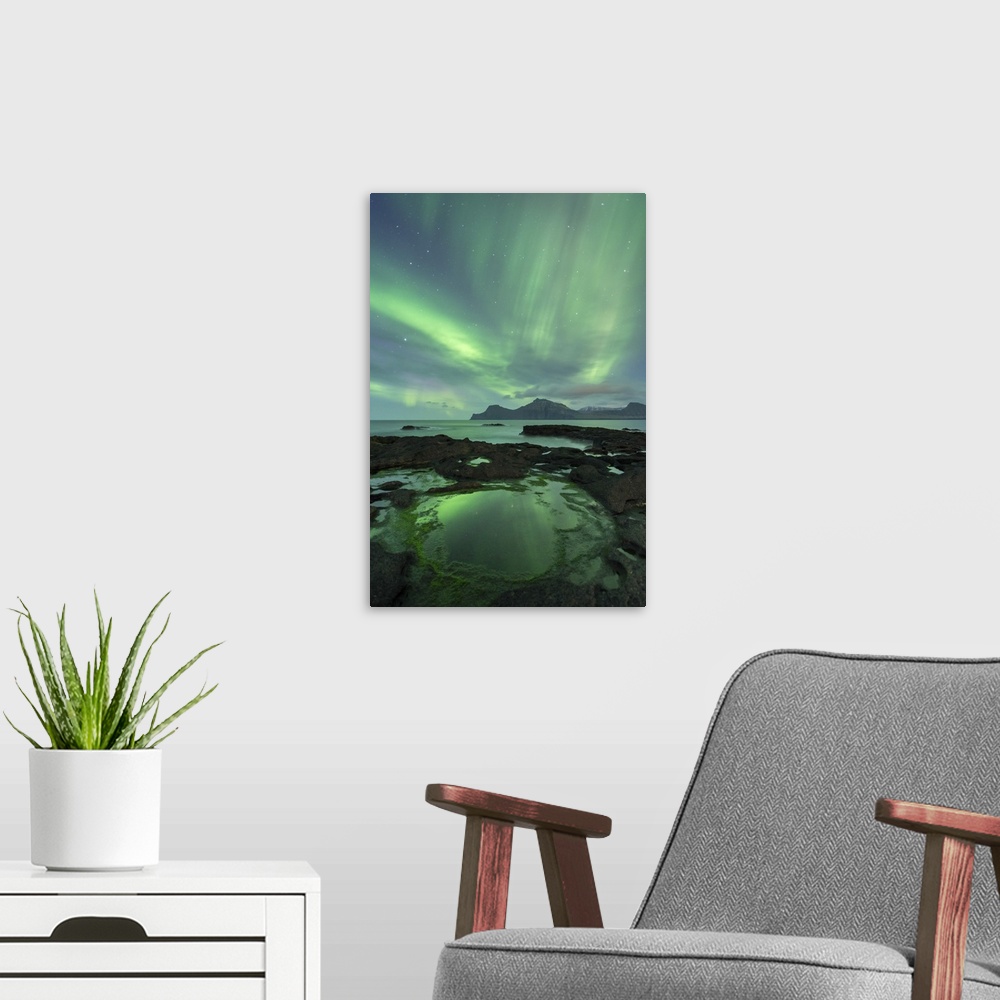 A modern room featuring Aurora Borealis above the island of Kalsoy, photographed from the coastline of Gjogv on the islan...