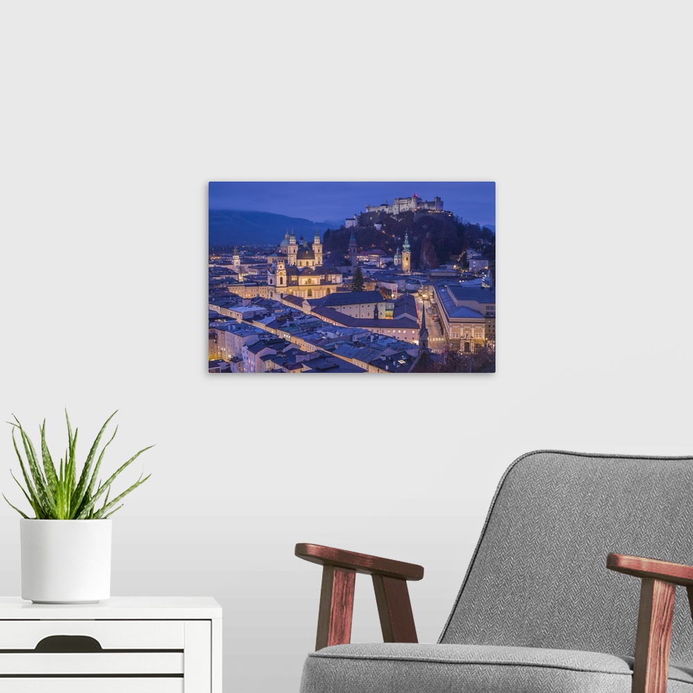 A modern room featuring Austria, Salzburgerland, Salzburg, elevated city view, dusk