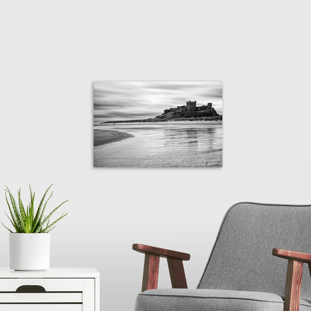 A modern room featuring Bamburgh castle and beach at low tide, Northumberland, UK