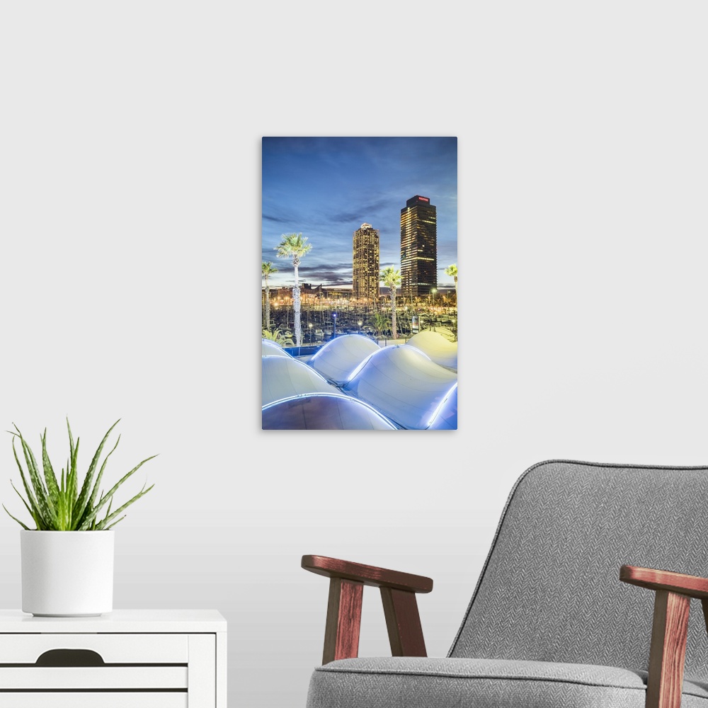 A modern room featuring Barcelona, Catalonia, Spain, Southern Europe. The twin towers of Mapfre Tower and Hotel Art at dusk.