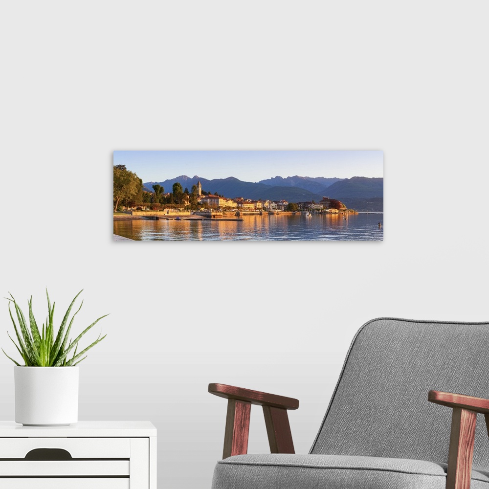 A modern room featuring The idyllic lakeside village of Baveno illuminated at sunrise, Lake Maggiore, Piedmont, Italy.