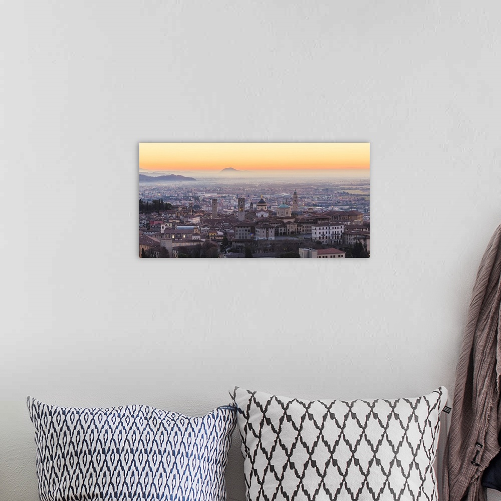 A bohemian room featuring Bergamo, Lombardy, Italy. High angle view over Upper Town (Citta Alta) at sunrise.