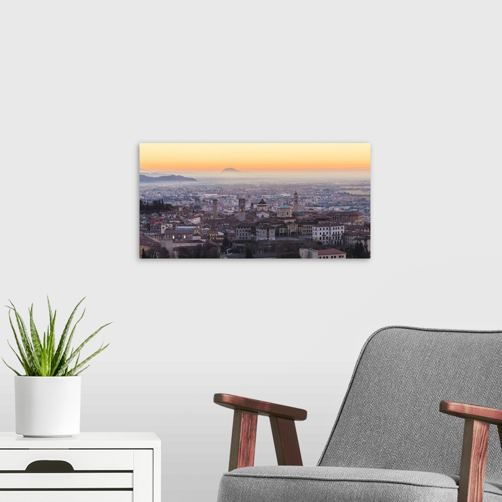 A modern room featuring Bergamo, Lombardy, Italy. High angle view over Upper Town (Citta Alta) at sunrise.