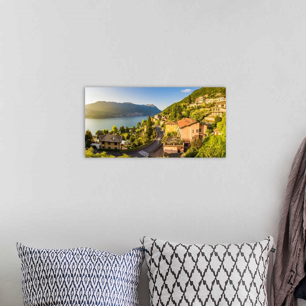A bohemian room featuring Blevio, lake Como, Como province, Lombardy, Italy. The winding coastal road at sunset.