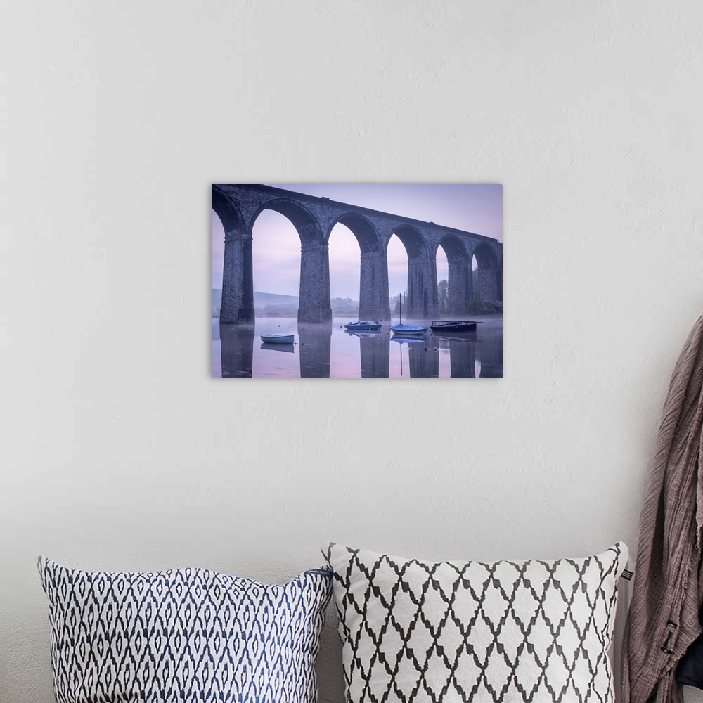 A bohemian room featuring Boats beneath St Germans Victorian viaduct at dawn, St Germans in Cornwall, England.  Spring (Apr...
