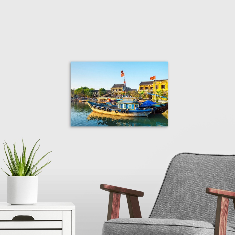 A modern room featuring Boats on the Thu Bon River in front of Hoi An Ancient Town in late afternoon, Hoi An, Quang Nam P...