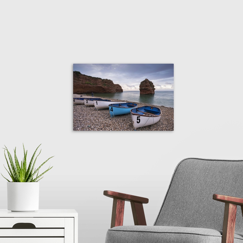 A modern room featuring Boats pulled up on the shingle at Ladram Bay on the Jurassic Coast, Devon, England. Autumn (Septe...