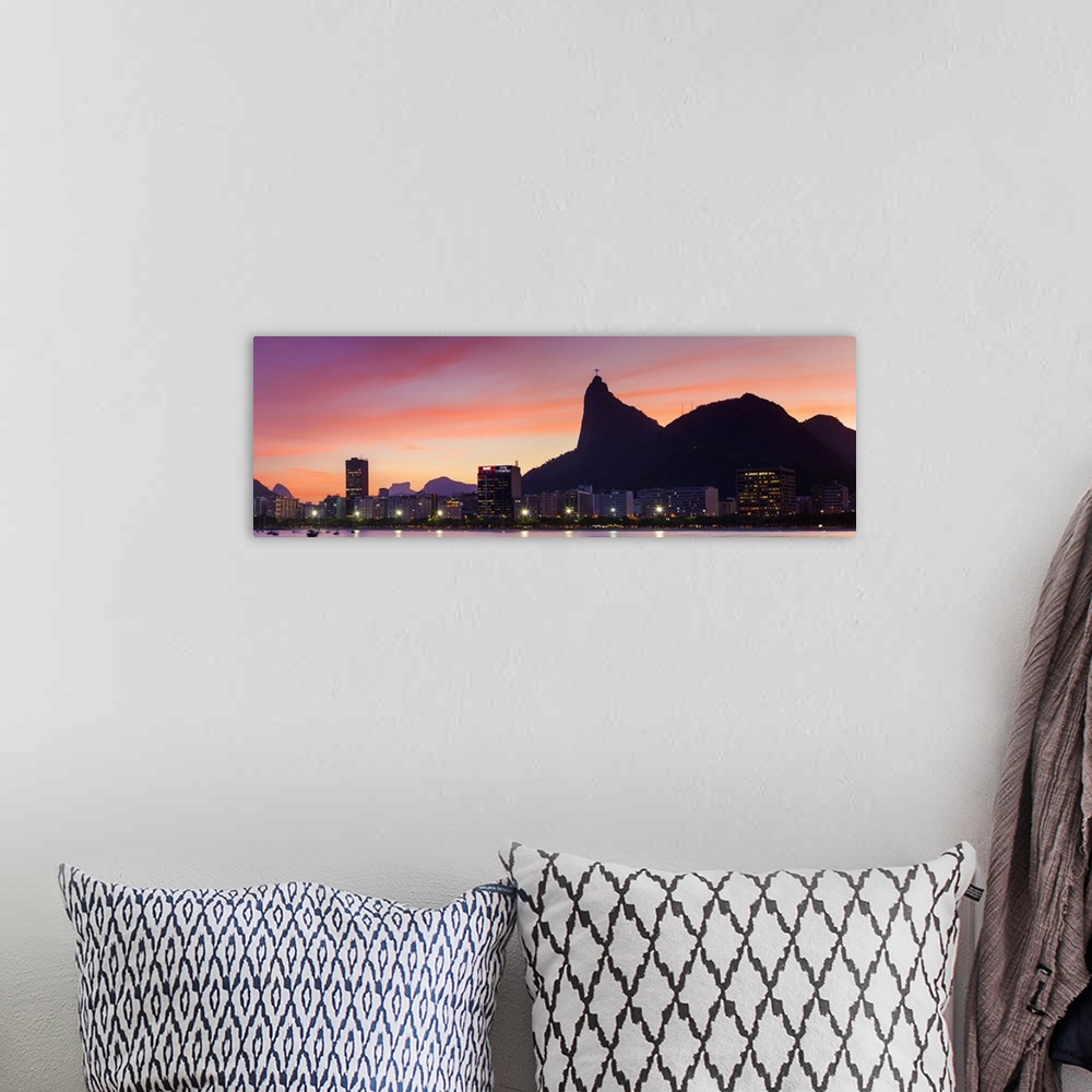 A bohemian room featuring Botafogo Bay and Christ the Redeemer statue at sunset, Rio de Janeiro, Brazil