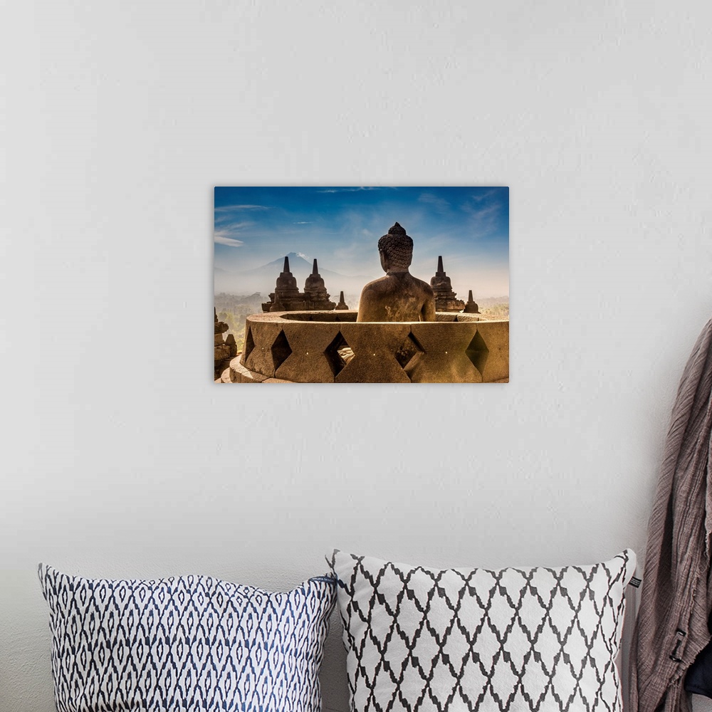 A bohemian room featuring Buddha statue with Mount Merapi in the background, Candi Borobudur Buddhist temple, Muntilan, Jav...