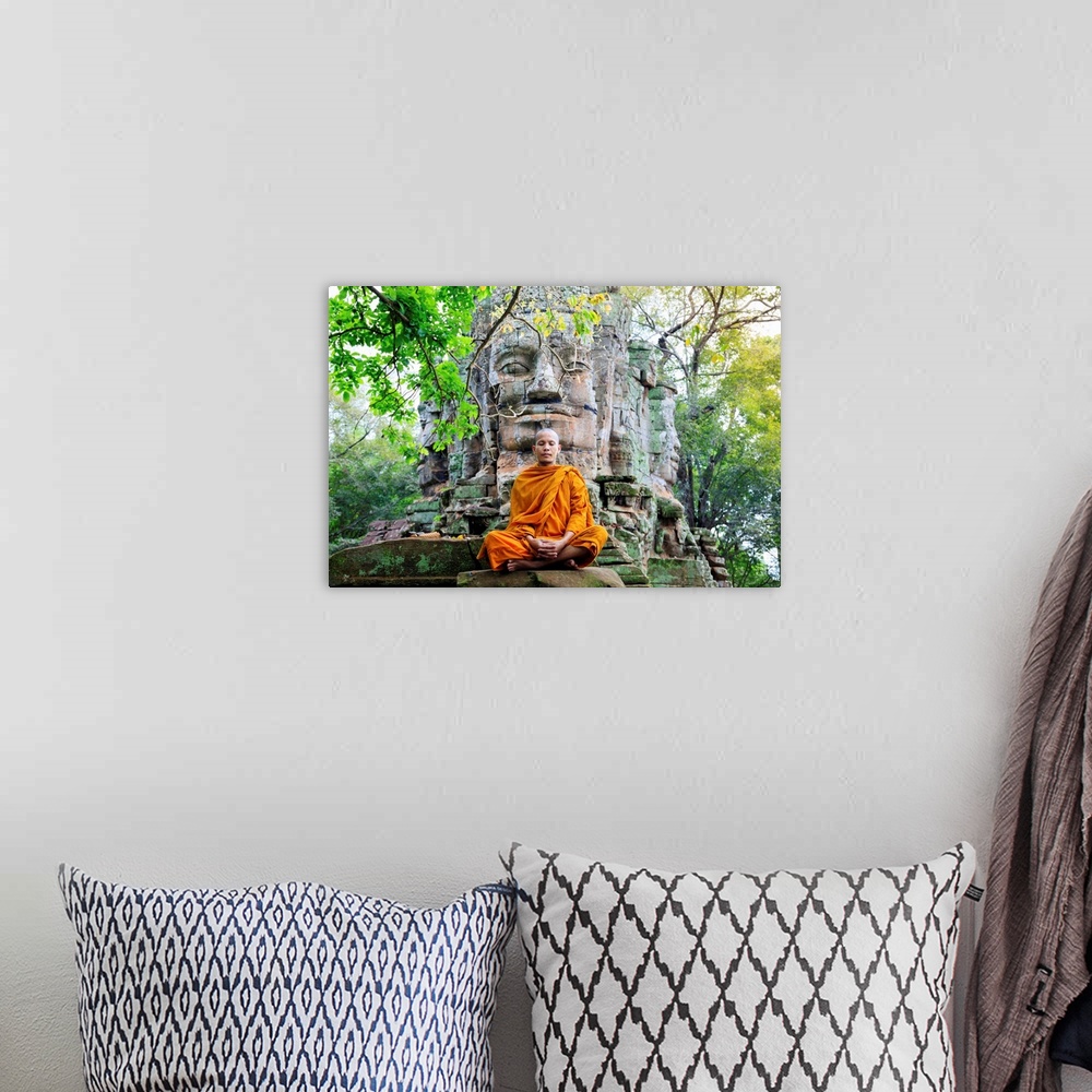 A bohemian room featuring Southeast Asia, Cambodia, Siem Reap, Angkor Temples, Buddhist Monk In Saffron Robes Meditating (MR)