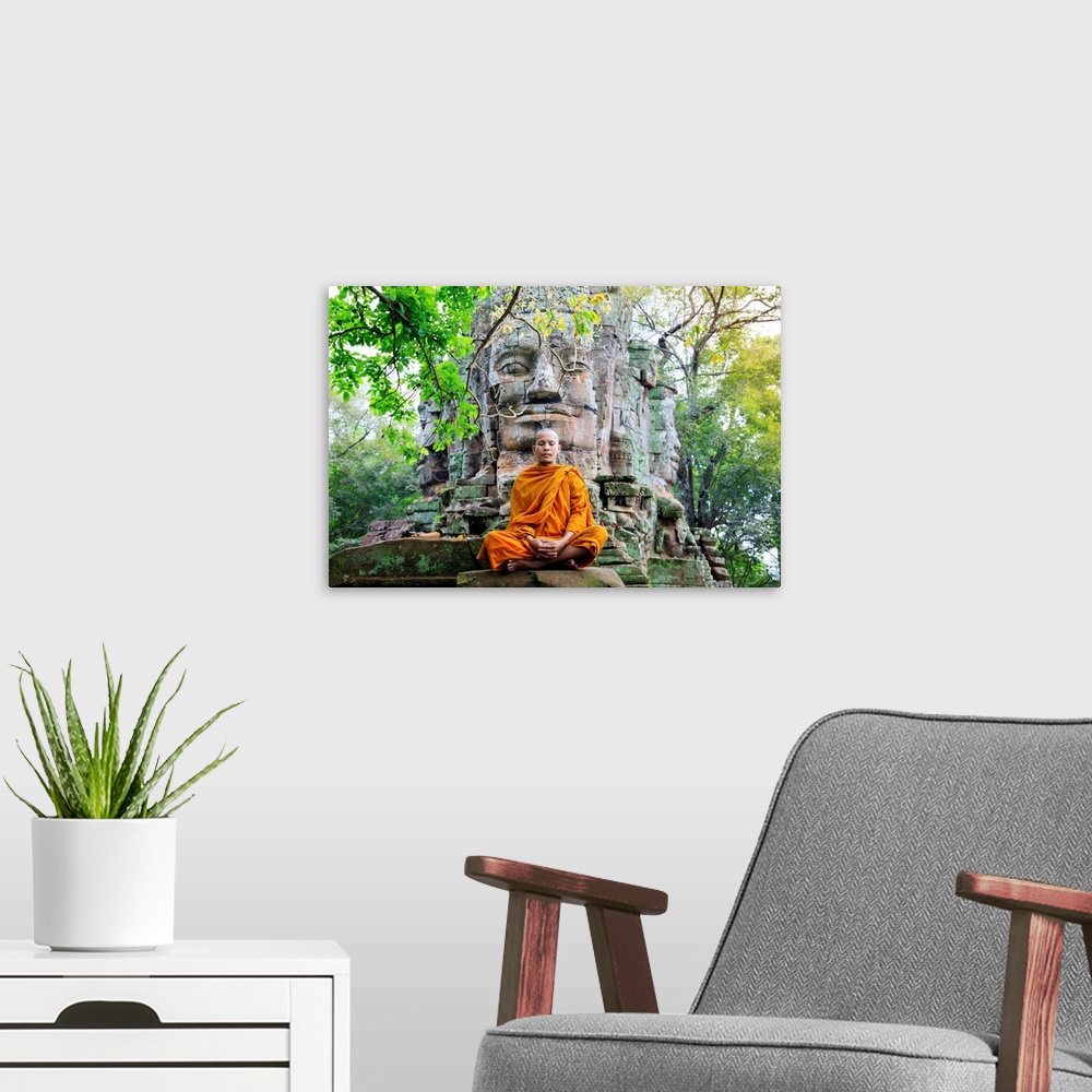 A modern room featuring Southeast Asia, Cambodia, Siem Reap, Angkor Temples, Buddhist Monk In Saffron Robes Meditating (MR)