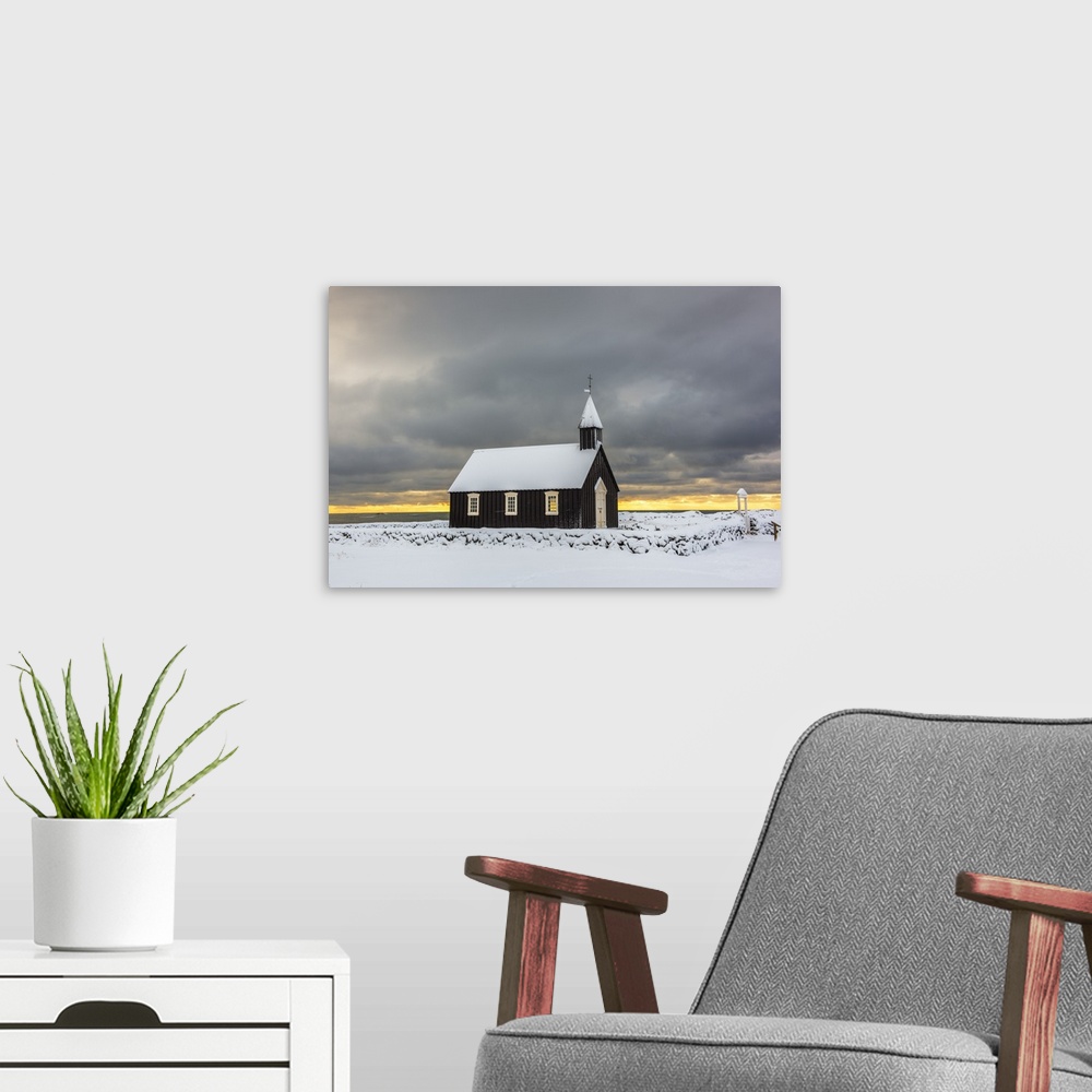 A modern room featuring Budir, Snaefellsnes Peninsula, Western Iceland, Iceland. Black church surrounded by the snow in w...