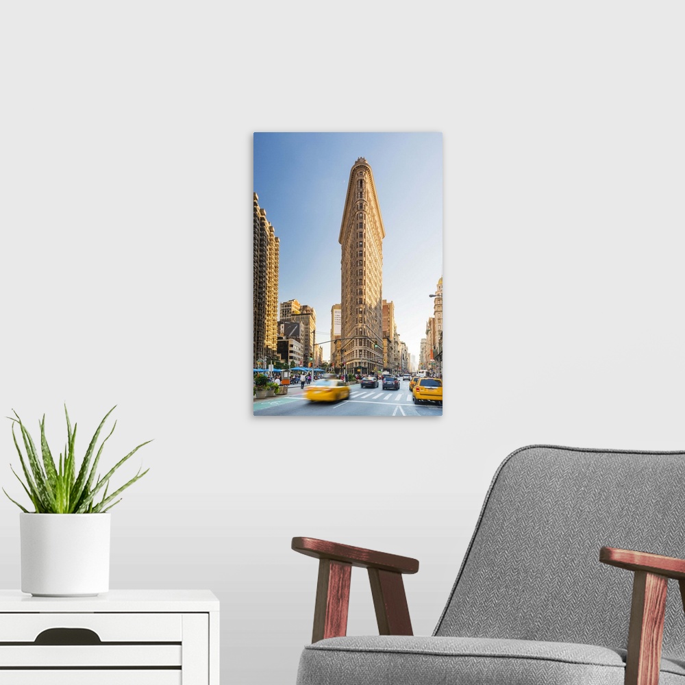 A modern room featuring Cabs passing under the Flat iron building, New York, USA.