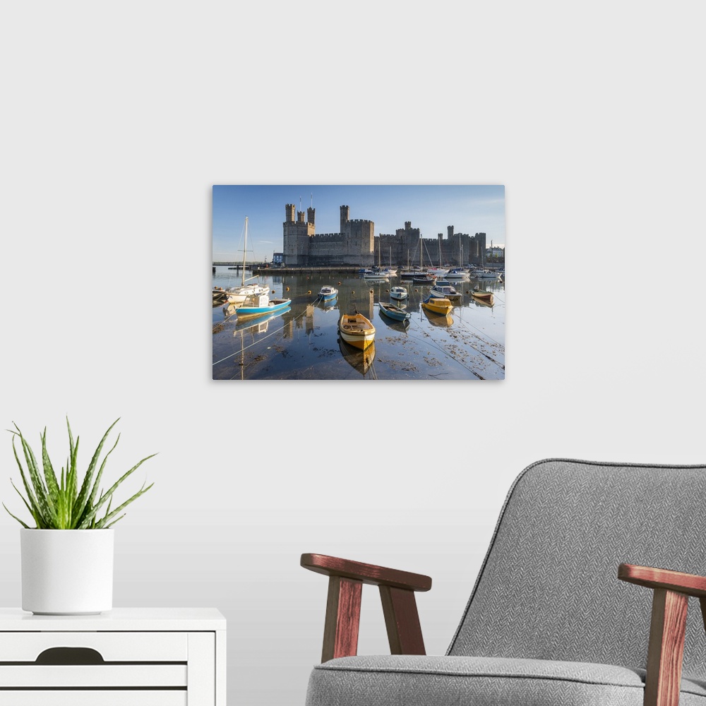 A modern room featuring Caernarvon Castle and boats, Snowdonia, Wales, UK