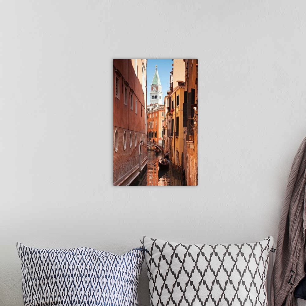 A bohemian room featuring Campanile and gondola on canal in Venice, Italy