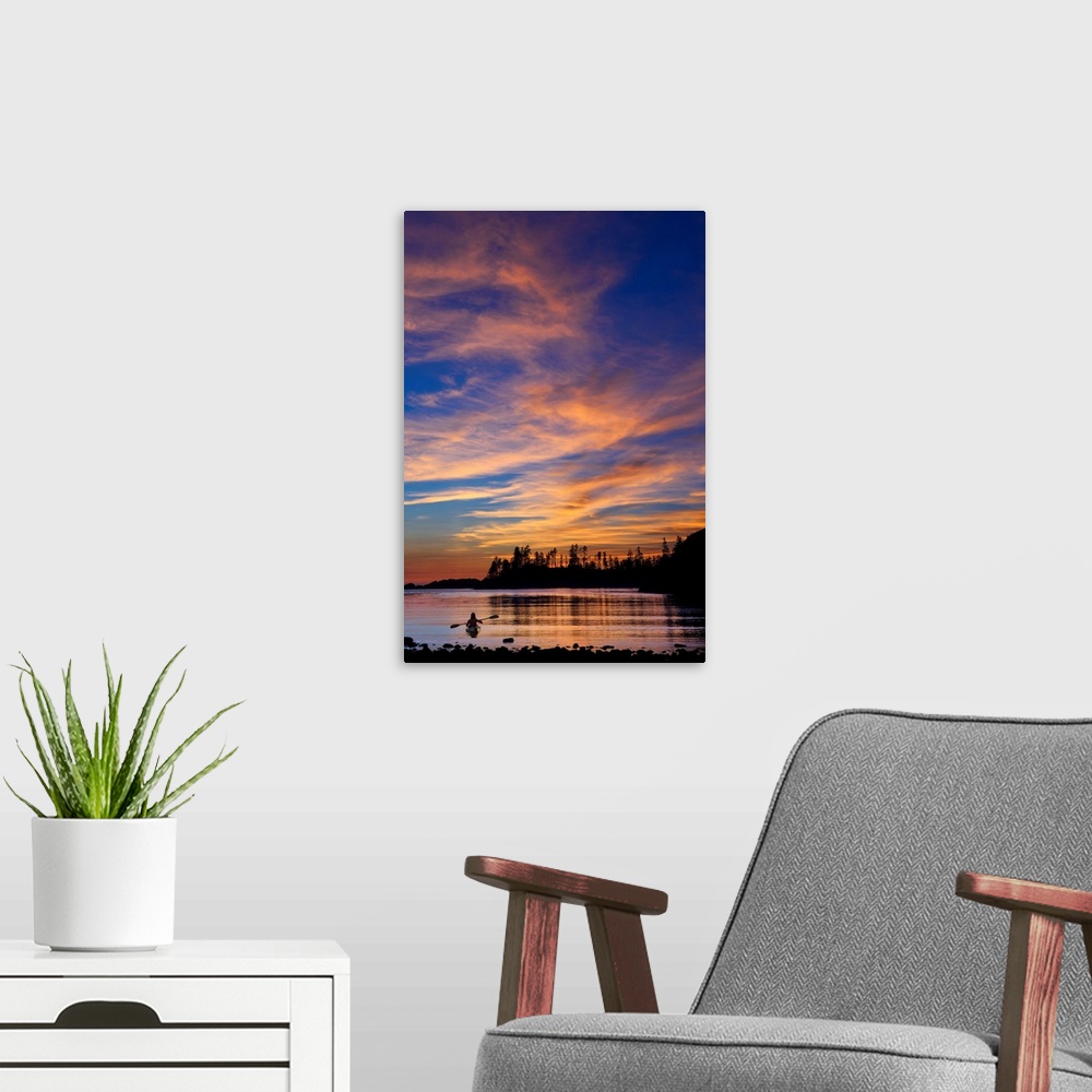 A modern room featuring Canada, British Columbia Vancouver Island, Ucluelet, West Coast, kayak at sunset.