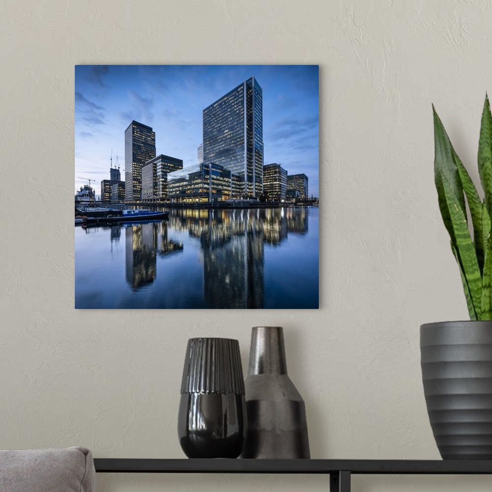 A modern room featuring Canary Wharf at dusk, Docklands, London, UK