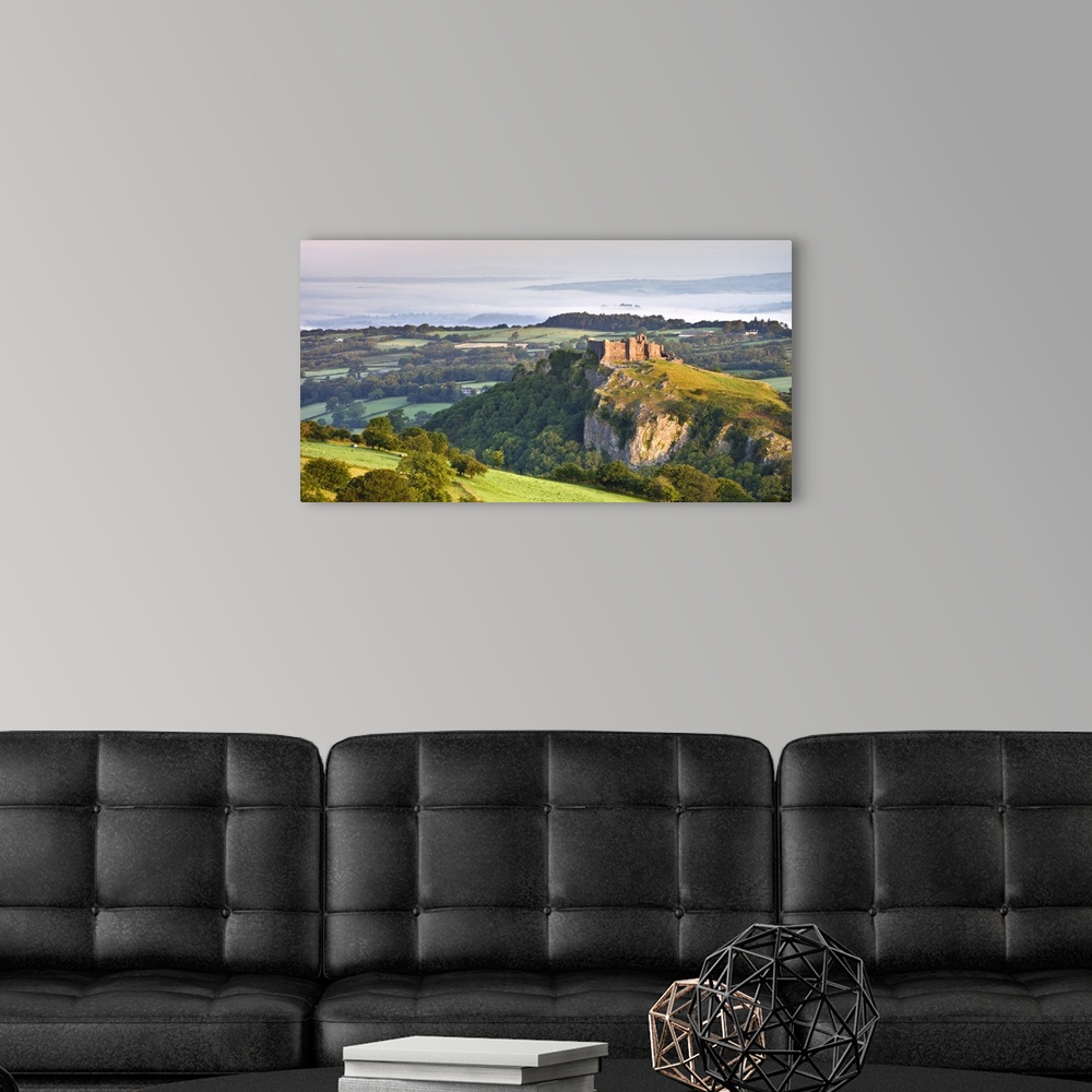 A modern room featuring Carreg Cennen Castle at dawn on a misty summer morning, Brecon Beacons National Park, Carmarthens...