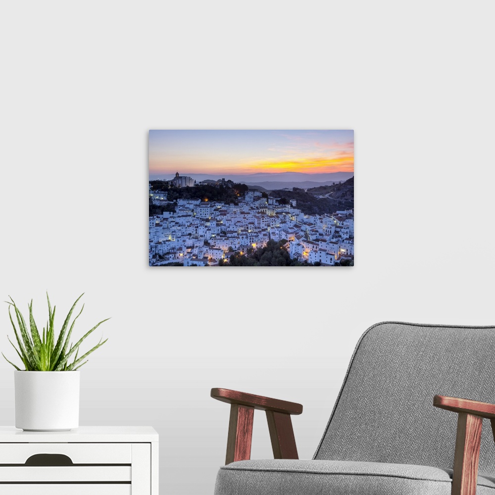 A modern room featuring Elevated view over the dramatic hilltop village of Casares illuminated at sunset, Casares, Malaga...