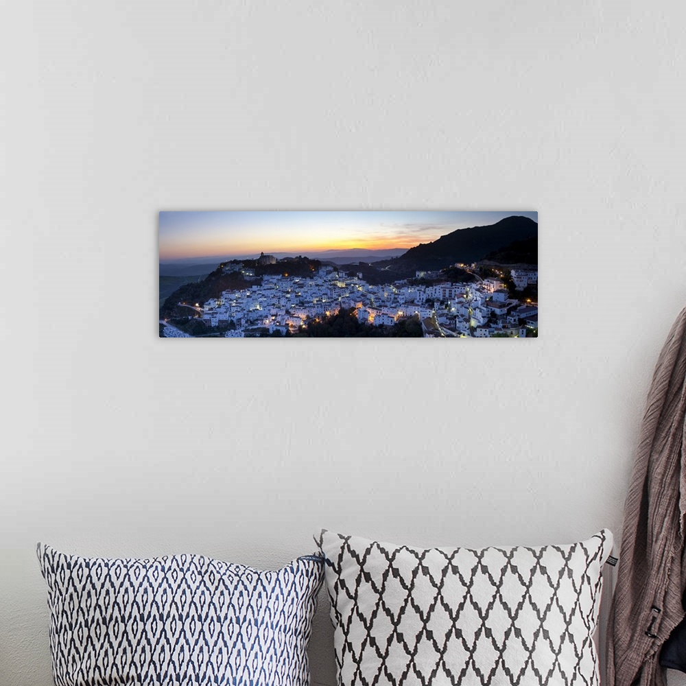 A bohemian room featuring Elevated view over the dramatic hilltop village of Casares illuminated at sunset, Casares, Malaga...