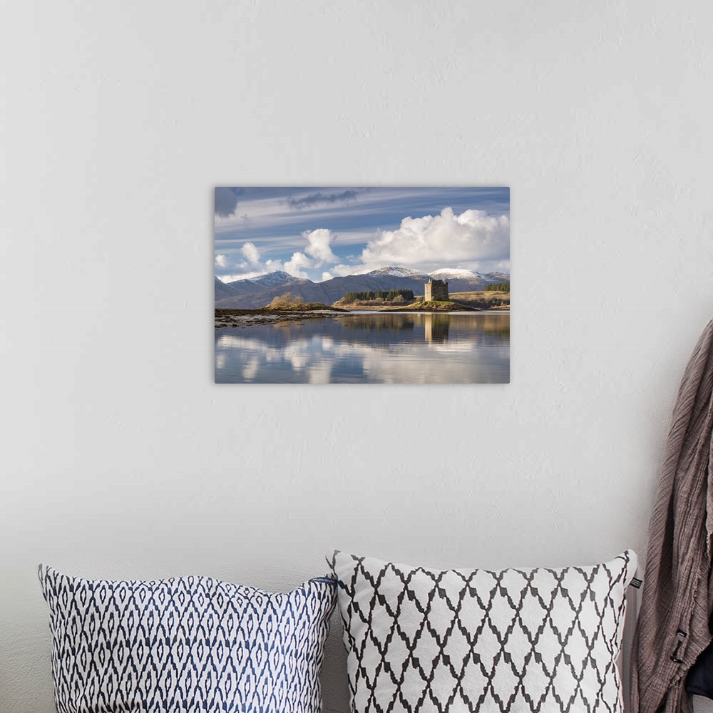 A bohemian room featuring Castle Stalker reflected on Loch Laich, and inlet off Loch Linnhe in the Scottish Highlands, Scot...