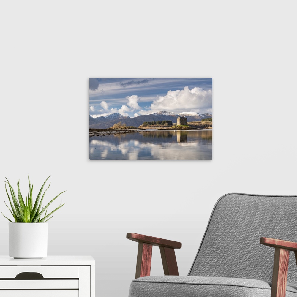 A modern room featuring Castle Stalker reflected on Loch Laich, and inlet off Loch Linnhe in the Scottish Highlands, Scot...
