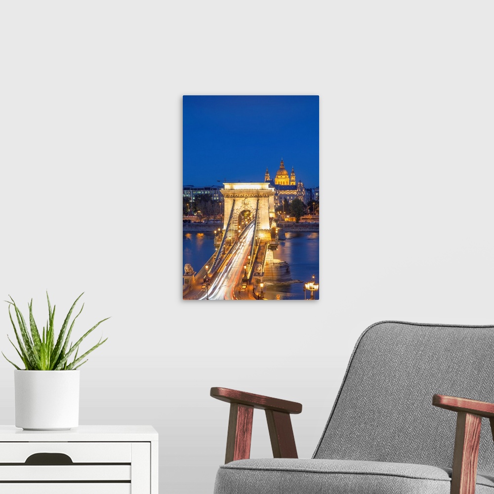 A modern room featuring Chain Bridge (Szechenyi Bridge) and St. Stephen's Basilica at dusk, Budapest, Hungary.