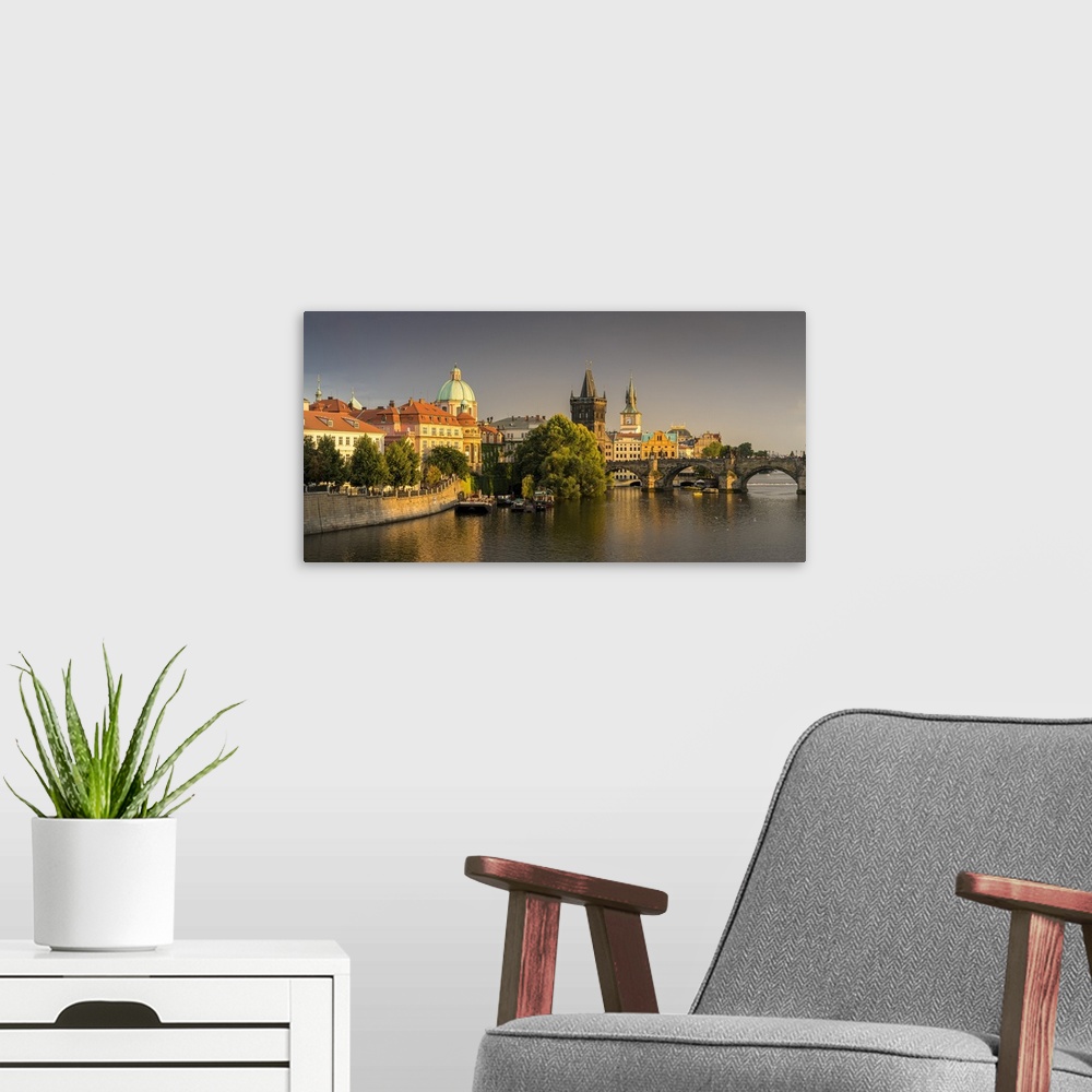 A modern room featuring Charles Bridge and Church of Saint Francis of Assisi with Old Town Bridge Tower against dark clou...