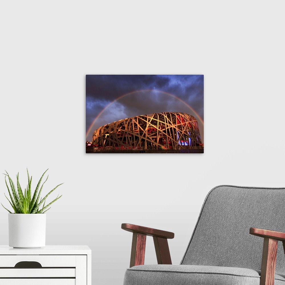 A modern room featuring China, Beijing, Olympic park and famous bird's nest stadium made of steel illuminated by a colorf...