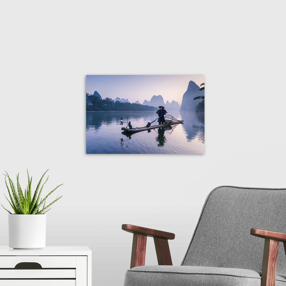 A modern room featuring China, Guanxi, Yangshuo. Old chinese fisherman at sunrise on the Li river, fishing with cormorant...