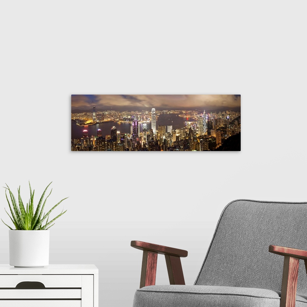 A modern room featuring China, Hong Kong, Victoria Peak. View over Hong Kong from Victoria Peak. The illuminated skyline ...